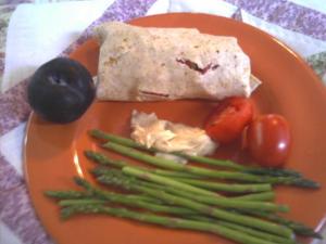 Whole wheat wrap with Morningstar Farms Spicy Black Bean Veggie burger, tomatoes and some Laughing Cow Cheese
